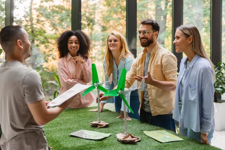 Event Management Company in Copenhagen, Denmark Business team participating in interactive sustainability workshop with wind turbine models and materials