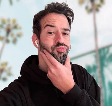 Ion, managing director, in contemplative pose outdoors with palm trees in background