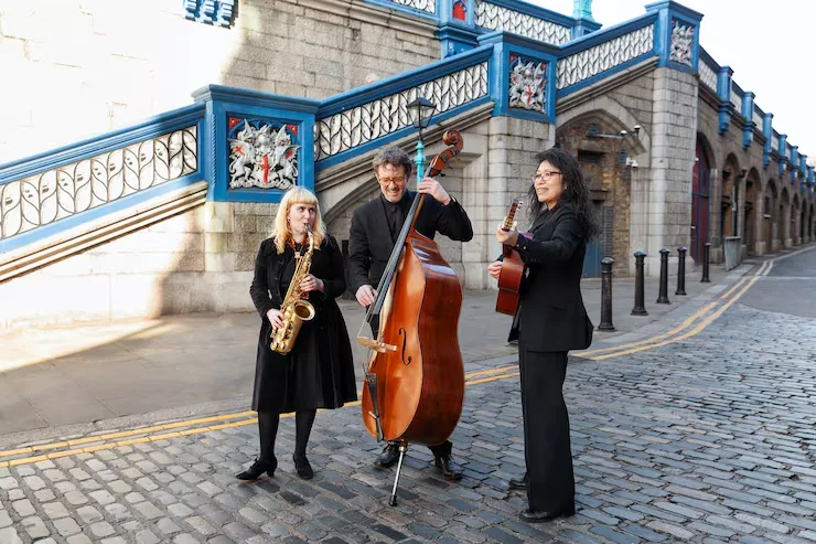 Professional jazz trio performing beneath Amsterdam's historic blue bridge during curated corporate event