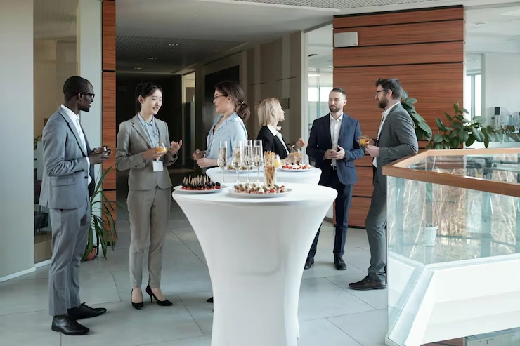 Event Management Company in Budapest, Hungary for Corporate and Private Events Business professionals networking at catered corporate reception with refreshments in modern Budapest venue