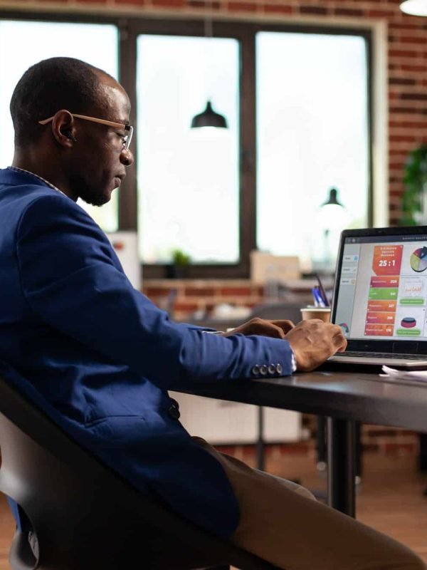 African american person using laptop to work on business charts and financial growth