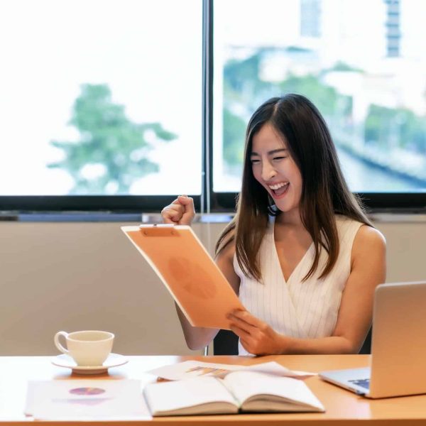 Asian businesswoman in casual suit are glad when looking the revenue in target