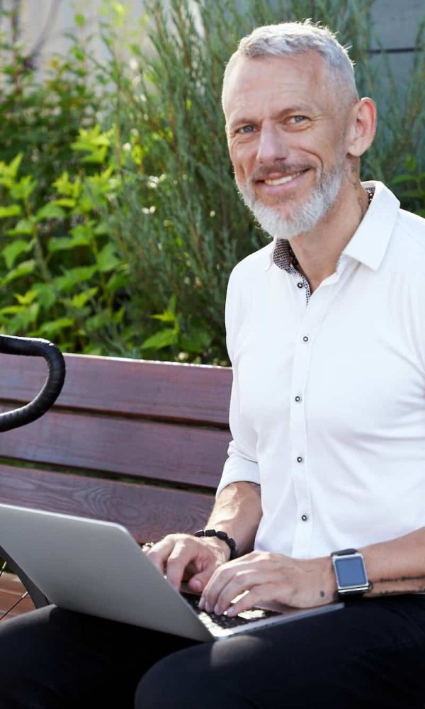 Building a Business. Successful modern middle aged businessman in stylish suit smiling at camera