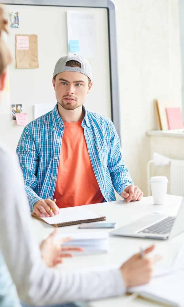 Handsome guy discussing university project with group mate, Influencer Marketing Agency