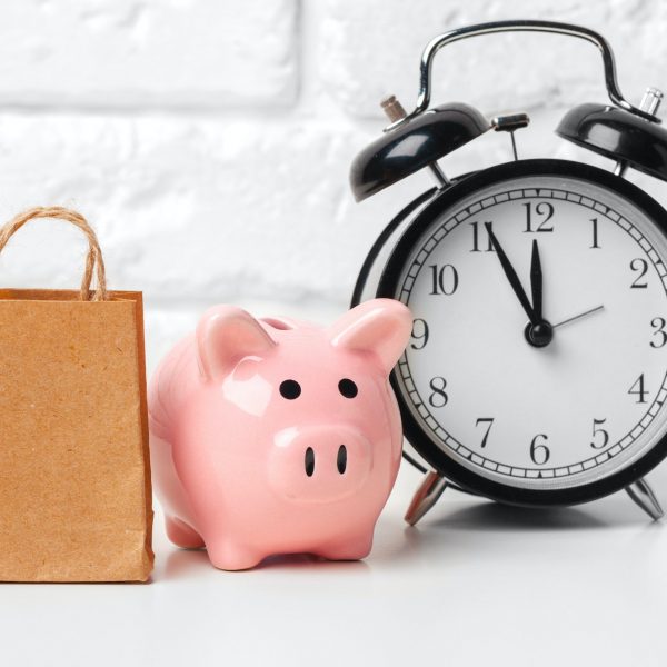 Piggy bank save coin and alarm clock, time and money concept.