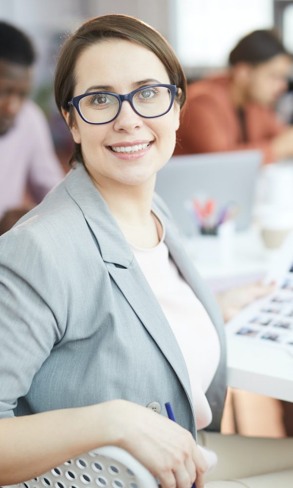 Smiling Businesswoman Posing in Production Agency
