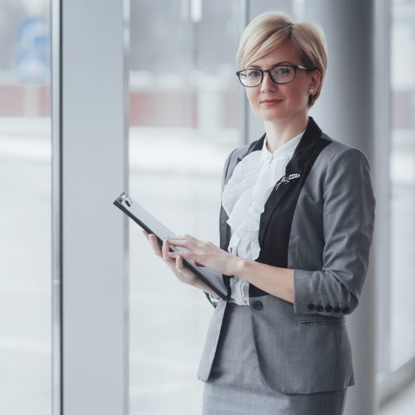 Smiling confident business woman looking at camera at office