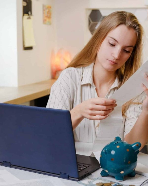 Woman checks sales receipt after shopping. Returning goods, calculating costs, planning own budget