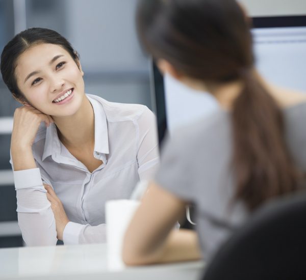 Young businesswomen talking in office