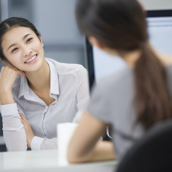 Young businesswomen talking in office
